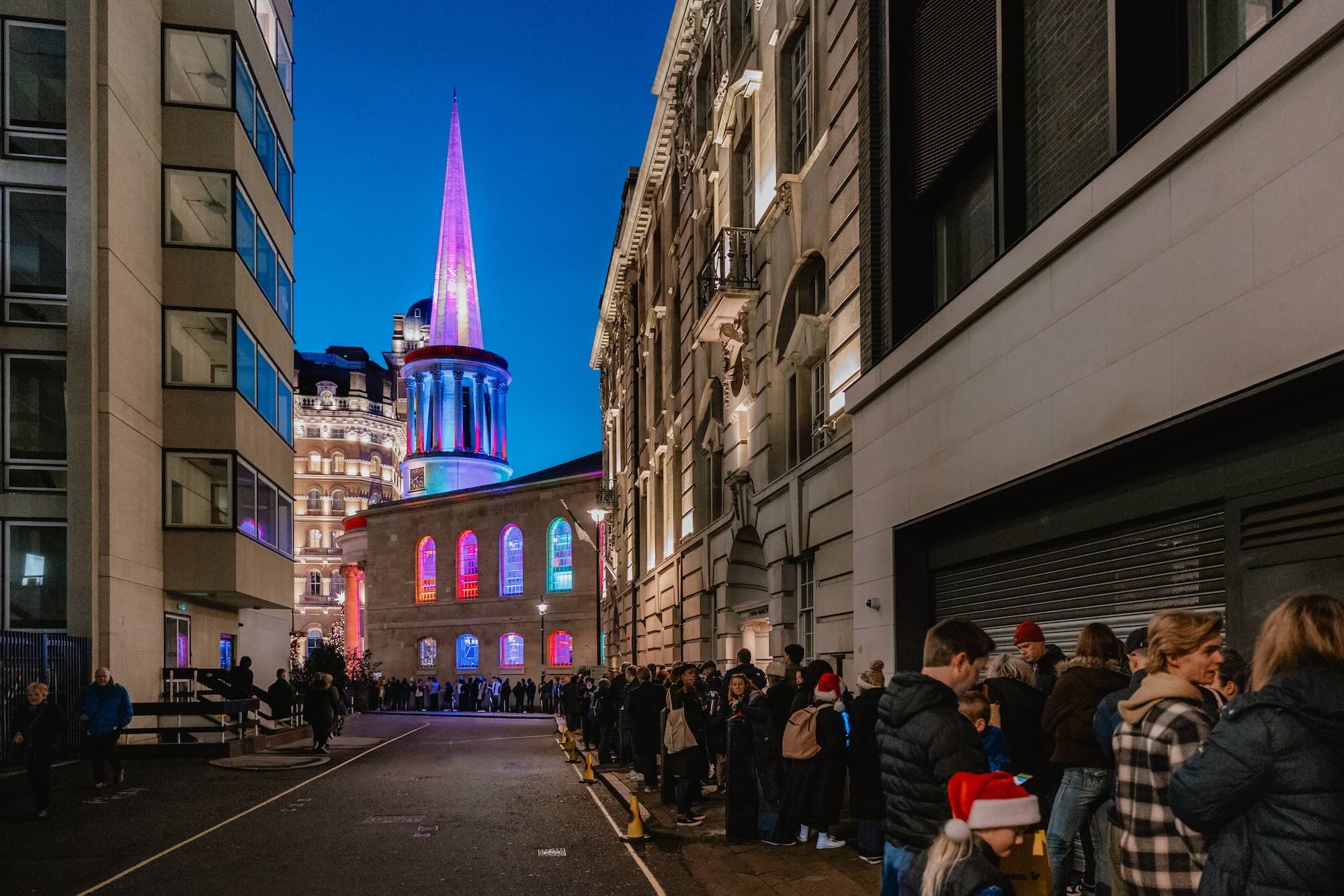 The queue at All Souls Carols stretches around the block, as the audience patiently waits to enter the colourful church in London's West End.